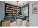 Inviting home office with custom built-in bookshelves and cozy seating by the window at 295 Sagamore Nw Cv, Sugar Hill, GA 30518