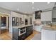 Modern kitchen with an island, stainless steel appliances, and hardwood floors at 295 Sagamore Nw Cv, Sugar Hill, GA 30518