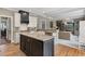 Well-designed kitchen with an island, stainless steel appliances, and an open layout to the living room at 295 Sagamore Nw Cv, Sugar Hill, GA 30518
