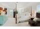Bright, spacious main bedroom with tray ceilings, canopy bed, and a sitting area at 295 Sagamore Nw Cv, Sugar Hill, GA 30518