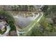 Scenic aerial view of a tranquil pond with lush greenery, a walking trail, and waterfront homes at 295 Sagamore Nw Cv, Sugar Hill, GA 30518