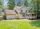 Spacious backyard featuring a lush lawn, screened porch, and mature trees providing ample shade at 5055 Southland Dr, Woodstock, GA 30188