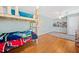 Bright bedroom featuring a bunk bed, hardwood floors, and playful decor at 5055 Southland Dr, Woodstock, GA 30188