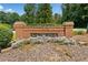 Charming brick sign for the Southlands community surrounded by lush greenery and landscaping at 5055 Southland Dr, Woodstock, GA 30188