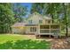 Home exterior with a well-maintained lawn and a charming screened-in porch at 5055 Southland Dr, Woodstock, GA 30188
