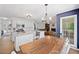 Open concept kitchen with an island, white cabinets, and a view into the dining area at 5055 Southland Dr, Woodstock, GA 30188