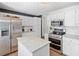 Well-lit kitchen features stainless steel appliances, an island, and plenty of cabinet storage at 5055 Southland Dr, Woodstock, GA 30188