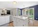 This open-concept kitchen boasts stainless steel appliances, an island, and access to dining and living spaces at 5055 Southland Dr, Woodstock, GA 30188