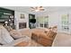 Spacious living room featuring a fireplace, built-in bookshelves, and access to a screened porch at 5055 Southland Dr, Woodstock, GA 30188