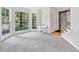 Bright living room with a bay window, neutral carpet, and a barn door leading to the foyer at 5055 Southland Dr, Woodstock, GA 30188