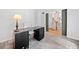 Home office with a desk, lamp, and view into the foyer and stairwell at 5055 Southland Dr, Woodstock, GA 30188