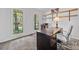 Bright home office with two windows, carpeted floors, and shelves at 5055 Southland Dr, Woodstock, GA 30188