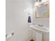 Compact powder room with pedestal sink and neutral decor at 5055 Southland Dr, Woodstock, GA 30188
