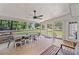 Relaxing screened porch with outdoor dining set and ceiling fan overlooking the backyard at 5055 Southland Dr, Woodstock, GA 30188