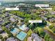Aerial view of the neighborhood featuring a community pool, tennis courts, and lush greenery at 5710 Waters Edge Trl, Roswell, GA 30075