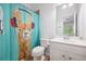 Bright bathroom featuring white vanity, toilet, and a fun shower curtain with a llama wearing headphones at 5710 Waters Edge Trl, Roswell, GA 30075