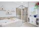 Bright bathroom with a relaxing tub and a glass-enclosed shower for a spa-like experience at 5710 Waters Edge Trl, Roswell, GA 30075