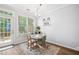 Cozy dining area with a modern table set and view of the back yard at 5710 Waters Edge Trl, Roswell, GA 30075