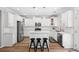 Bright kitchen with white cabinets, stainless steel appliances, and a breakfast bar at 5710 Waters Edge Trl, Roswell, GA 30075