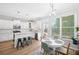 Eat-in kitchen area with stainless appliances, white cabinets, and a modern table set at 5710 Waters Edge Trl, Roswell, GA 30075
