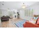 Open-concept living room with a fireplace, modern furniture, and natural light at 5710 Waters Edge Trl, Roswell, GA 30075