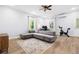 Cozy living space featuring a comfortable gray sofa, a desk, and plenty of natural light at 5710 Waters Edge Trl, Roswell, GA 30075