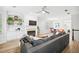 Spacious living room featuring a fireplace, hardwood floors, and an open floor plan at 5710 Waters Edge Trl, Roswell, GA 30075