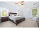 Comfortable main bedroom with a ceiling fan, vaulted ceiling, and natural light at 5710 Waters Edge Trl, Roswell, GA 30075