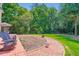 Spacious backyard with a brick patio, lush greenery, and ample space for outdoor enjoyment at 965 Grimes Bridge Rd, Roswell, GA 30075