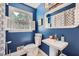 Stylish blue bathroom featuring a pedestal sink, a large mirror, and white accents at 965 Grimes Bridge Rd, Roswell, GA 30075