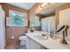 Neutral bathroom featuring a large mirror, a white vanity, and matching toilet at 965 Grimes Bridge Rd, Roswell, GA 30075
