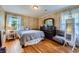 Cozy bedroom with hardwood floors, bright windows, and floral wallpaper at 965 Grimes Bridge Rd, Roswell, GA 30075