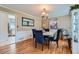 Elegant dining room with hardwood floors, wainscoting, and stylish blue chairs at 965 Grimes Bridge Rd, Roswell, GA 30075