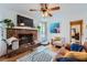 Comfortable living room featuring a brick fireplace and hardwood floors, perfect for relaxation and entertaining at 965 Grimes Bridge Rd, Roswell, GA 30075