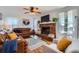 Cozy living room featuring a brick fireplace, hardwood floors, and comfortable leather seating at 965 Grimes Bridge Rd, Roswell, GA 30075