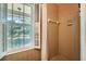 Neutral tiled bathroom featuring a shower with a window and a shower curtain at 965 Grimes Bridge Rd, Roswell, GA 30075