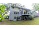 Backyard view featuring a screened porch and a well-manicured lawn at 3873 Rains Ne Ct, Brookhaven, GA 30319