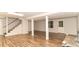 Finished basement featuring laminate floors, neutral walls, support beams, and access to the backyard at 3873 Rains Ne Ct, Brookhaven, GA 30319