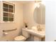 Bathroom with a sleek pedestal sink, updated fixtures, and accessible grab bar at 3873 Rains Ne Ct, Brookhaven, GA 30319