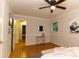 Another view of the bedroom displaying hardwood floors, a ceiling fan, and views from the window at 3873 Rains Ne Ct, Brookhaven, GA 30319