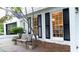 Close up of a white brick home with dark shutters, bench and manicured bushes at 3873 Rains Ne Ct, Brookhaven, GA 30319