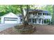 Inviting two-story white home with well-maintained landscaping and a brick driveway at 3873 Rains Ne Ct, Brookhaven, GA 30319