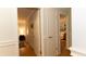 Hallway featuring wood floors, paneling, doors, and access to other rooms in the home at 3873 Rains Ne Ct, Brookhaven, GA 30319