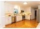 White kitchen with stainless steel appliances, tile backsplash, and parquet hardwood floors at 3873 Rains Ne Ct, Brookhaven, GA 30319