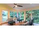 Sunroom with tile floor, multiple windows, and a ceiling fan for year-round comfort at 3873 Rains Ne Ct, Brookhaven, GA 30319