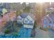 Aerial view of a two-story home, with an attached two-car garage and a landscaped front yard at 5105 Riverthur Pl, Duluth, GA 30096
