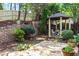 Well-maintained backyard with a stone patio, terraced landscaping, and a quaint gazebo at 5105 Riverthur Pl, Duluth, GA 30096