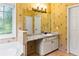 Bright bathroom with a single sink vanity, granite counters and flower-themed wallpaper at 5105 Riverthur Pl, Duluth, GA 30096