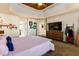 Comfortable bedroom showcasing the king-size bed, TV, walk-in closet, and neutral color palette at 5105 Riverthur Pl, Duluth, GA 30096