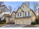 Stucco home with a two-car garage, featuring shutters and a well-manicured lawn in a suburban neighborhood at 5105 Riverthur Pl, Duluth, GA 30096